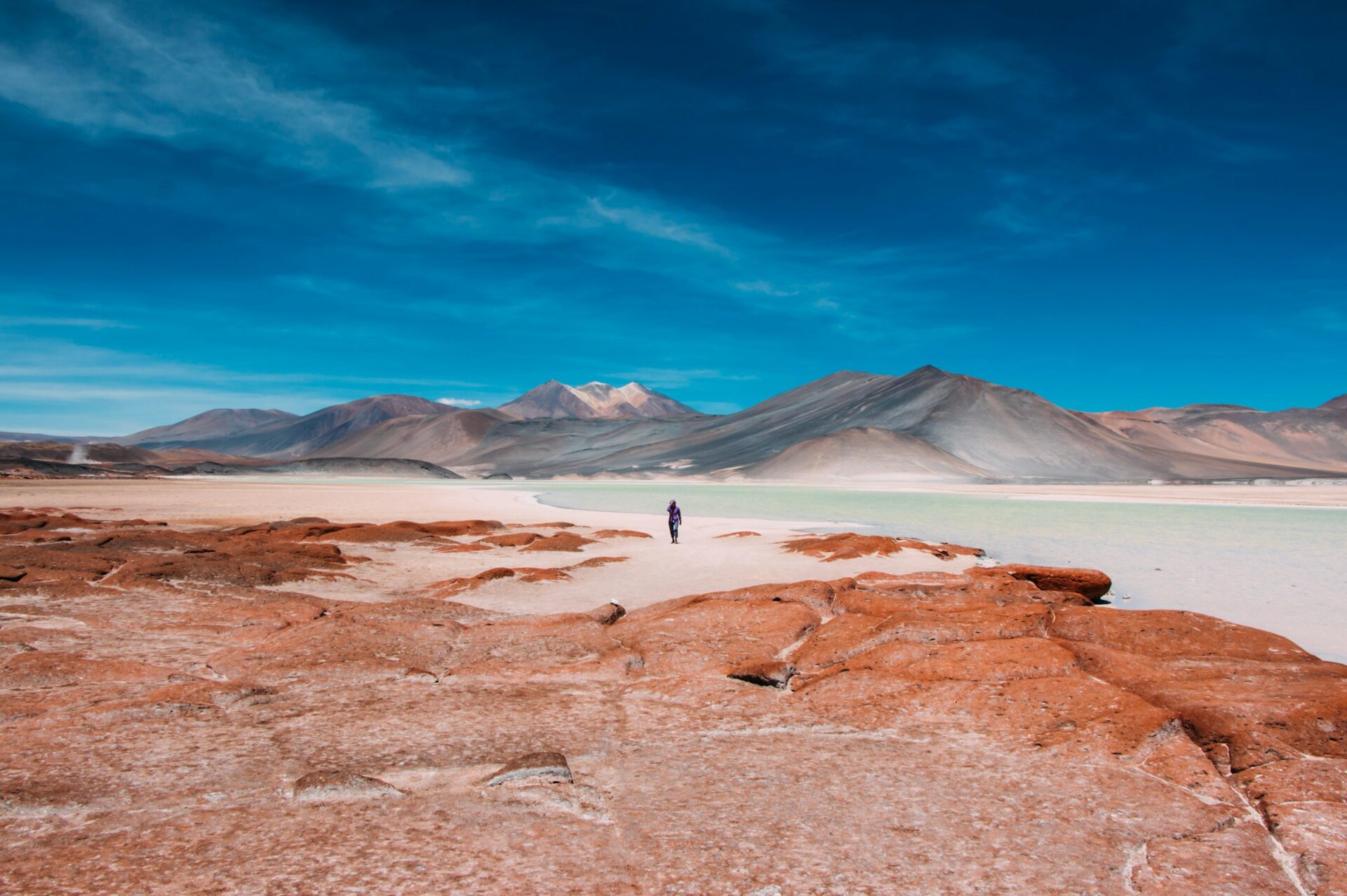 person walking in distance of mountain
